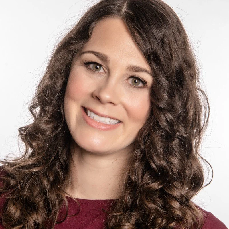 A middle-aged woman with brown hair on white background