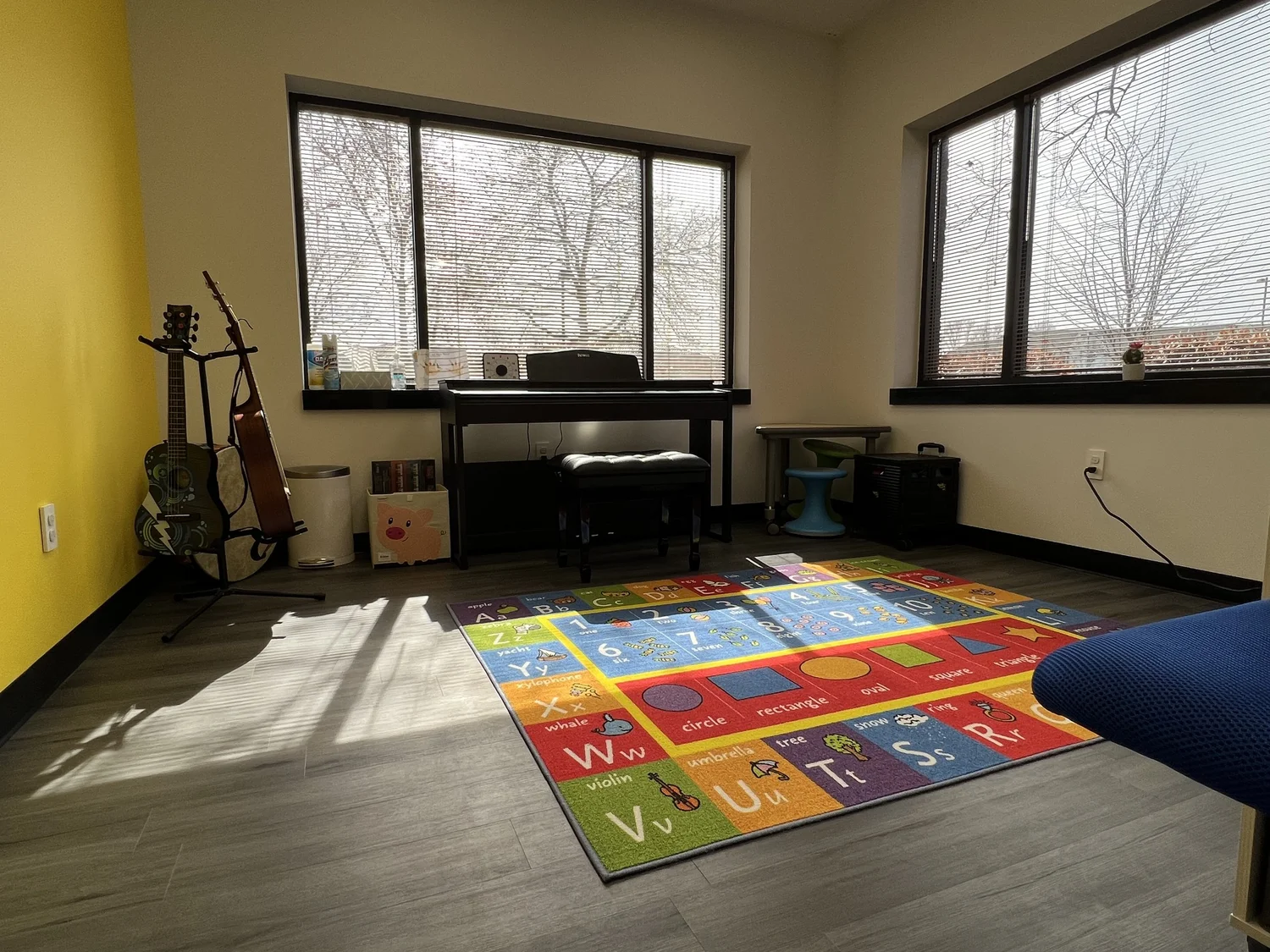 Yellow Treatment Room with 88 note piano, swing hook, table, wobble chairs, and plenty of instruments 
